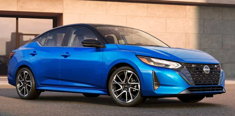 A blue 2025 Nissan Sentra parked in a driveway.